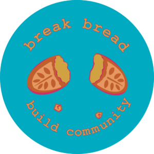 Illustration with turquoise background of a split bread loaf. It reads "break bread build community" with little crumbs falling from the loaf.